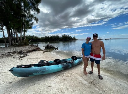 a group of people on a beach near a body of water