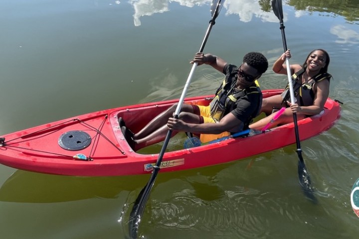 a man riding on the back of a boat in a body of water