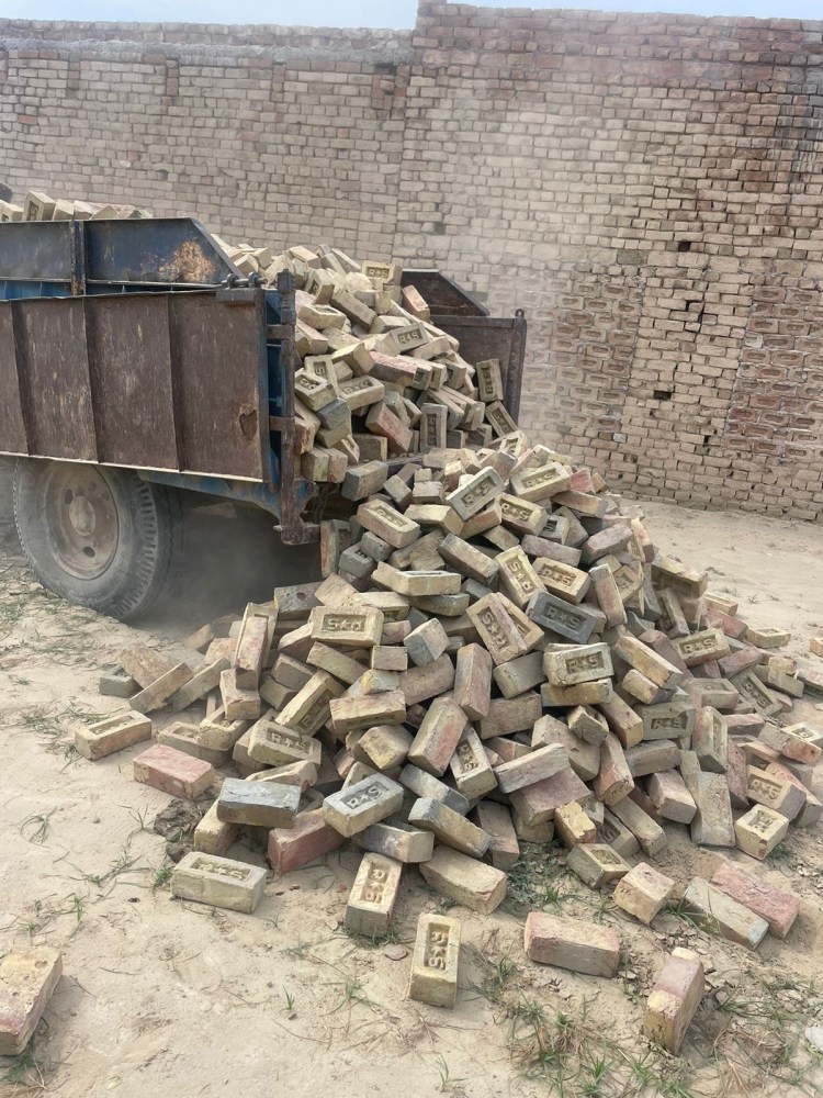 a pile of dirt in front of a building