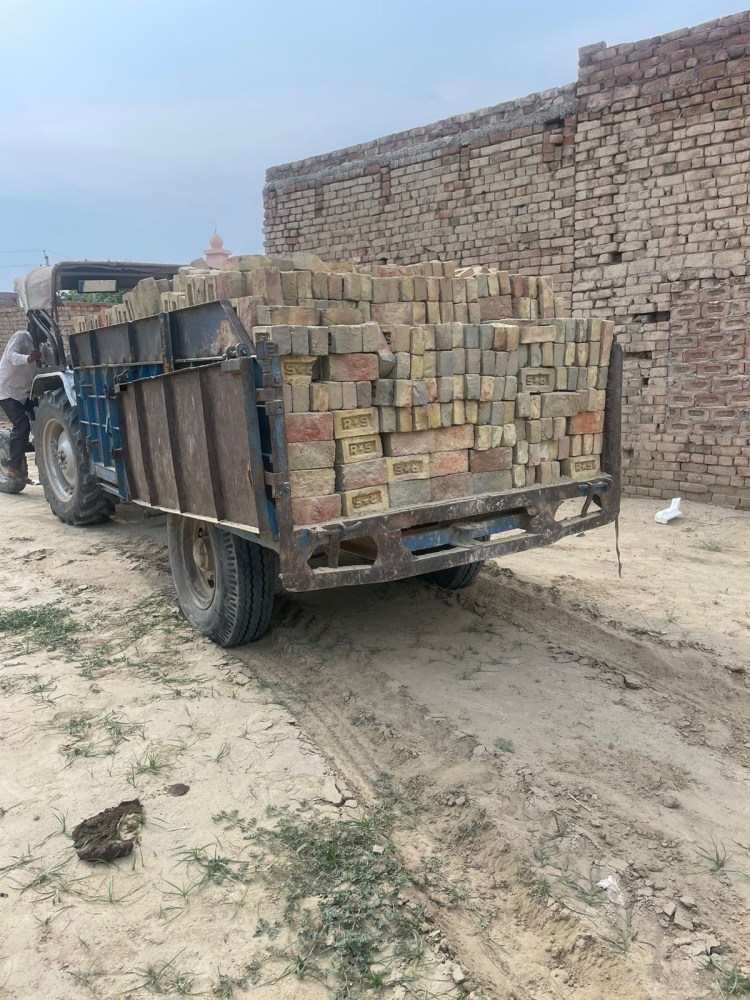 a truck driving down a dirt road