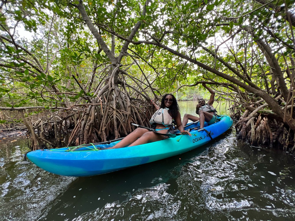 a person riding on the back of a boat in the water