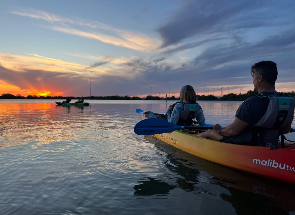 a man sitting in a boat on a body of water